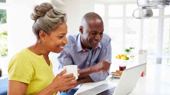 Black couple looking at their pc